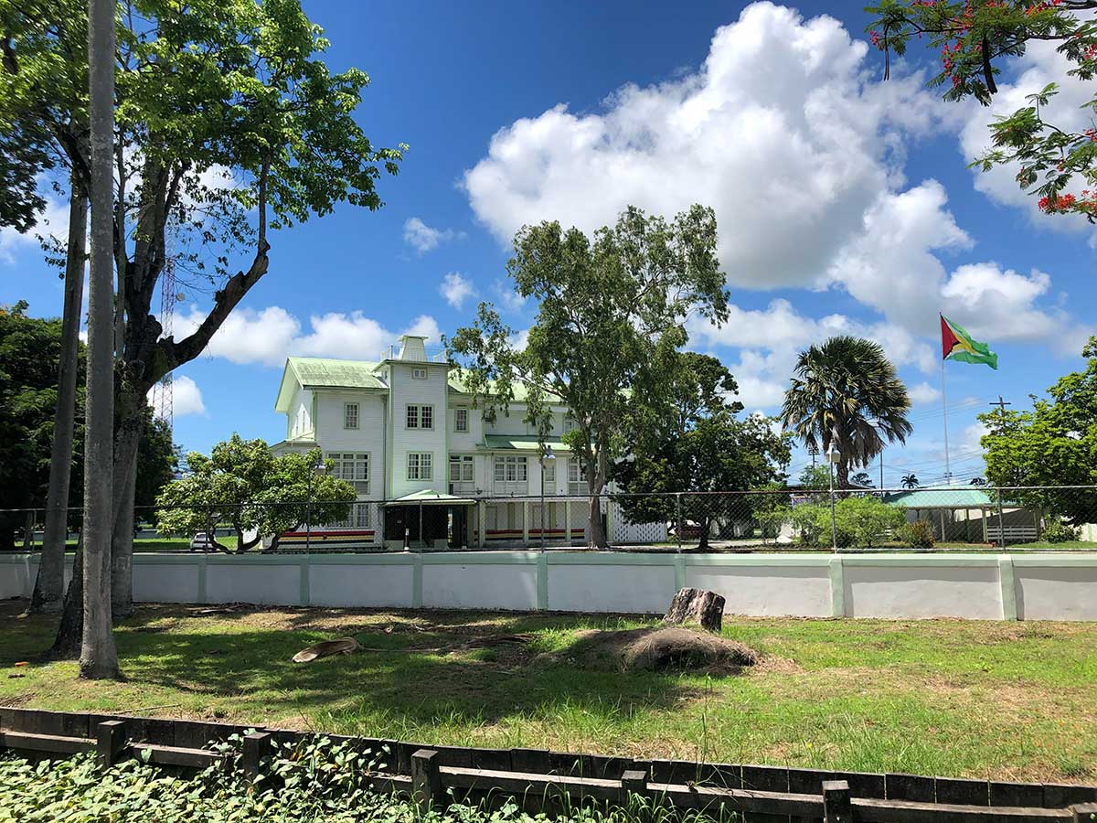 a farm house with a flag waving in the wind